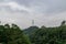 There are clouds and signal towers in the forest after the rain