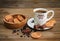 There are Cookies,Candy,Chocolate Peas,Poppy;Porcelain Saucer and Cap with Coffe,Tasty Sweet Food on the Wooden Background