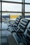 There are empty chairs, benches for passengers waiting for flights at the airport terminal, selected focus