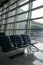 There are empty chairs, benches for passengers waiting for flights at the airport terminal, selected focus