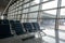 There are empty chairs, benches for passengers waiting for flights at the airport terminal, selected focus