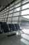 There are empty chairs, benches for passengers waiting for flights at the airport terminal, selected focus