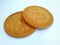 There are light brown biscuits with milk flavor, on a white background