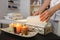 There are lit aromatic candles on the table, a spa center employee puts towels for treatments