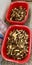 There are a lot of morels in a plastic red container after picking mushrooms in the forest