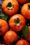 There are a lot of wet persimmon fruits. Selective focus.