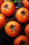 There are a lot of wet persimmon fruits. Selective focus.