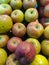 there are lots of apples lined up on supermarket shelves