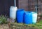 There are many rain barrels in the garden