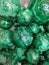 There are many semi-precious stones of round shape and emerald color