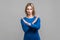 There is no way. Portrait of woman crossing hands, showing block, X sign, this is the end. indoor studio shot isolated on gray