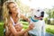 There is nothing like the love of a pet. a woman bathing her pet dog outside on a summers day.