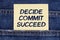 There is a paper sticking out of a jeans pocket with the inscription - Decide Commit Succeed