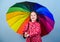 There is rainbow always after the rain. Enjoy rain concept. Fall season. Kid girl happy hold colorful rainbow umbrella
