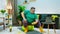There s an obese man with glasses he has a beard and he s sitting on a yellow yoga ball, he is very concerned on getting