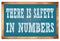 THERE IS SAFETY IN NUMBERS words on blue wooden frame school blackboard