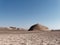 there is a very large pyramid in the middle of this desert