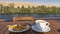 There is a wooden table and chair on the deck of the cruise ship.