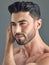 Theres no doubt that a good haircut makes us feel better. a handsome young man posing against a grey background.