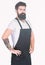 Theres no doubting he looks good. Bearded man wearing barber or cooking apron. Long bearded man keeping arms crossed