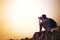 Theres no fogging his focus. a young photographer taking a picture of a foggy landscape from the top of a mountain.