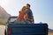 Theres nothing greater than the open road. a young couple relaxing on the back of a pickup truck while on a road trip.