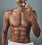 Theres a time and a place for everything, even beards. Studio shot of a handsome and shirtless young man shaving his