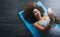 Theres always time for yoga and a selfie. High angle shot of a young woman practising yoga.