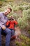 Theres a whole world waiting to be discovered. a little boy looking through binoculars while on a hike with his father.