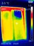 A thermographic image of a building window showing different temperatures in different colors, from blue indicating cold to red