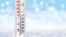 The thermometer on a blurred winter background shows 15 degrees below zero
