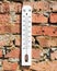 Thermometer on a brick wall