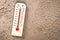 Thermometer on Dry soil ground cracks background texture show higher Weather