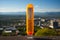 A thermometer on a ledge overlooking a city. Generative AI image.