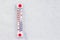 The thermometer lies in the snow and shows a subzero temperature. Weather forecast. Copy space_