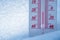 The thermometer lies on the snow in winter showing a negative temperature. Meteorological conditions in a harsh climate in winter