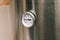 The thermometer is mounted on a stainless steel boiler. Autonomous heating of a house or apartment. Heated cold water