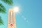 A thermometer outdoors in the summer in the sun shows hot weather temperature, it`s time to sunbathe on the beach. Mockup for pos