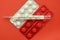 Thermometer pills on a red background. Flu epidemic, coronavirus. Temperature 37.2 C.