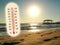 Thermometer showing the temperature rise in the summer sun and seaside photo koncept