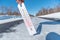 The thermometer shows a negative temperature in cold weather against the background of an icy road or highway.Poor weather