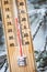 Thermometer with subzero temperature stuck in the snow in the winter