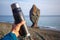 Thermos in a hand of man near the coast of Sakhalin Island