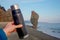 Thermos in a hand of man near the coast of Sakhalin Island