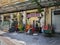 Thessaloniki, Greece Empty outdoors tables with colorful wooden chairs stacked outside.