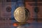 Theta Network THETA Crypto Coin Placed on reflective surface with twenty dollar bill behind