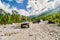 Theth, Albania - July 24, 2014. Two vintage off road cars on the dirt road in albanian mountains