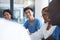 Theyll figure it out together. a group a medical professionals sitting in the hospital boardroom during a meeting.