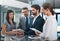 Theyre all a part of the team. a group of businesspeople looking over a digital tablet in the office.