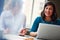 Theyre both actively involved in the planning phase. two businesswomen using a laptop together in an office.